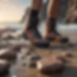 A pair of high-performance reef booties on a rocky beach
