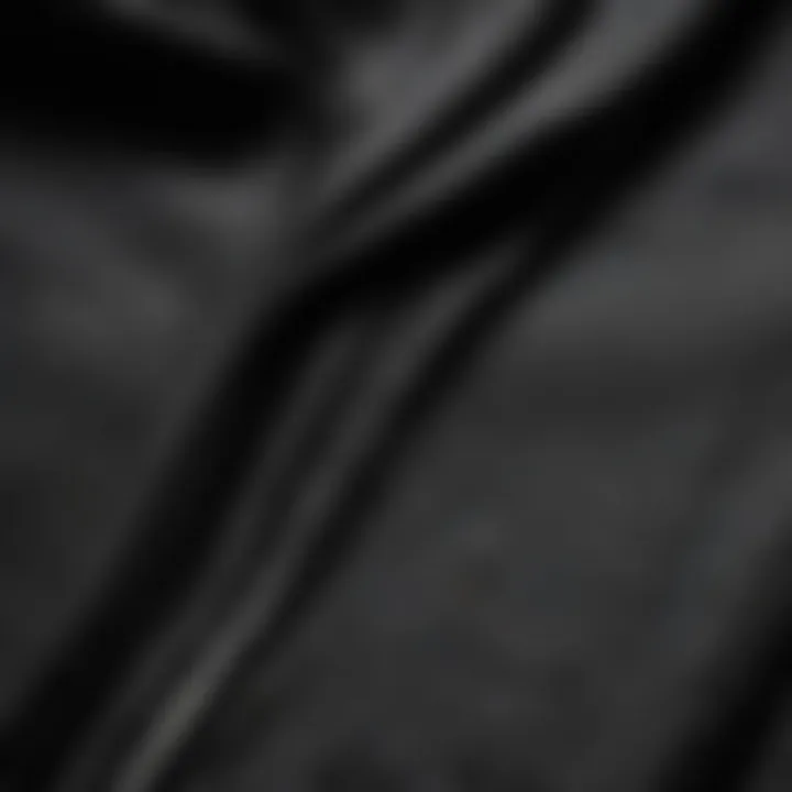 Close-up of the fabric texture of a black zip-up hoodie, highlighting durability and comfort