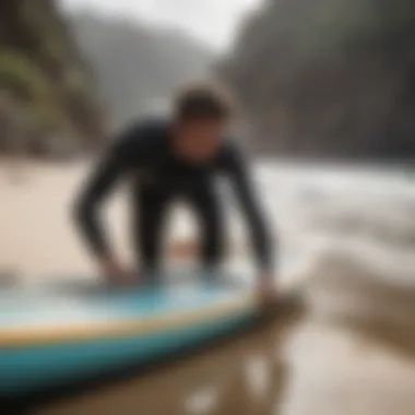 A surfer loading their surfboard into a day bag