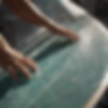 A surfer applying resin to a damaged surfboard