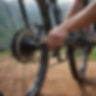 A mountain biker inspecting the chain of a bike, emphasizing maintenance practices.