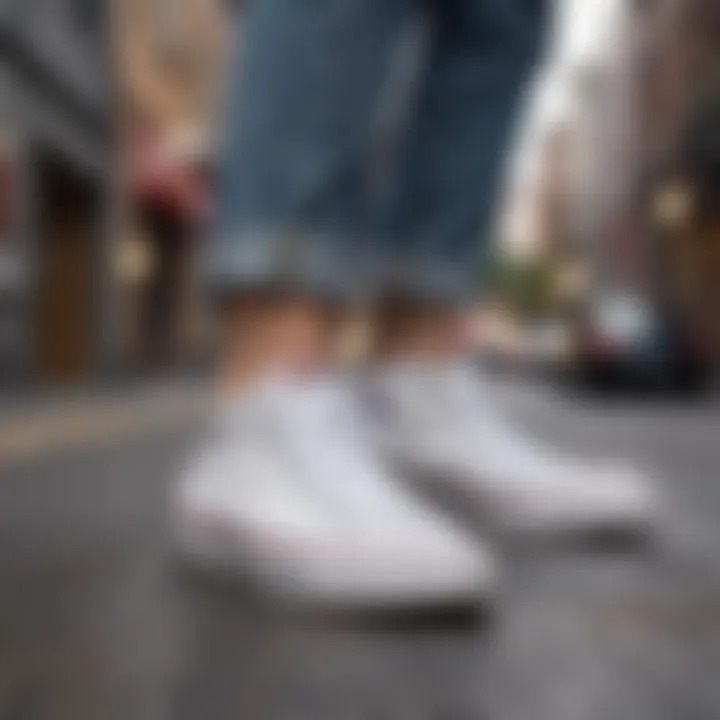 A stylish individual wearing Converse all white canvas sneakers in an urban environment.