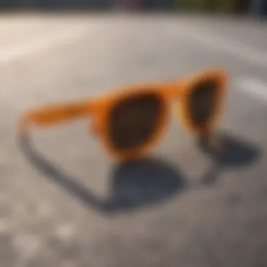 Stylish orange round sunglasses placed on a skateboarding deck