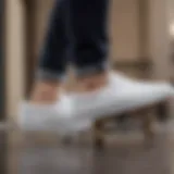 White Vans slip-on skate shoes on a skateboard