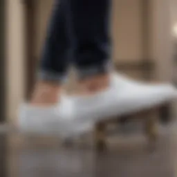 White Vans slip-on skate shoes on a skateboard