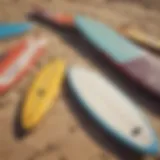 A vibrant collection of second hand surf boards displayed on a sandy beach