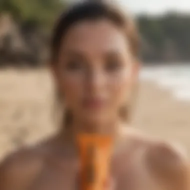 Close-up of Sun Bum sunscreen tube with beach background