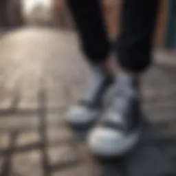 Classic black Converse sneakers on a cobblestone street