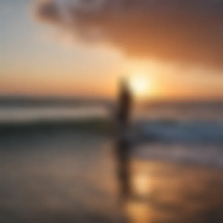 Sunset over the ocean with surfers in the water