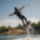 A dynamic wakeboarder in mid-air executing a trick over a winch setup